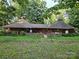 Charming home boasts unique architecture and a beautiful stone wall, complemented by a well-manicured lawn at 404 Long Shoals Rd, Bessemer City, NC 28016