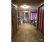 Unique hallway with tile flooring, textured ceiling, and multiple doorways leading to other rooms at 404 Long Shoals Rd, Bessemer City, NC 28016