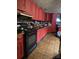 A kitchen with red cabinets and black appliances at 404 Long Shoals Rd, Bessemer City, NC 28016
