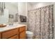 Bathroom featuring wood cabinet, sink, mirror, and shower with patterned curtain at 4079 Murray St, Fort Mill, SC 29707