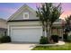 Charming home with gray siding, manicured lawn, and a two-car garage at sunset at 4079 Murray St, Fort Mill, SC 29707