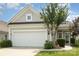 Home boasts gray siding, a well-maintained lawn, and a two-car garage at 4079 Murray St, Fort Mill, SC 29707