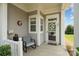 Inviting front porch with neutral colors, comfortable chair, and decorative wreath on the front door at 4079 Murray St, Fort Mill, SC 29707