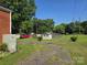 Large backyard featuring a shed, outbuildings and mature trees at 412 Ridge St, Stanley, NC 28164