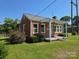 Quaint brick home with a covered front porch and manicured lawn at 412 Ridge St, Stanley, NC 28164