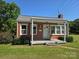 Inviting brick home with covered porch and landscaped front yard at 412 Ridge St, Stanley, NC 28164