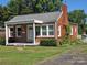Charming brick home with a well-maintained front yard and cozy covered entrance at 412 Ridge St, Stanley, NC 28164
