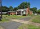 Charming brick home with well-maintained landscaping and a cozy front porch at 412 Ridge St, Stanley, NC 28164