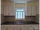 Traditional kitchen featuring ample white cabinetry and a double sink at 412 Ridge St, Stanley, NC 28164