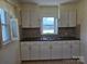 Traditional kitchen featuring ample white cabinetry and a double sink at 412 Ridge St, Stanley, NC 28164