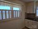 Kitchen featuring white cabinets, dark countertops, and a window with natural light at 412 Ridge St, Stanley, NC 28164