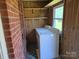 Bright laundry room featuring the washing machine, storage shelving, and a window at 412 Ridge St, Stanley, NC 28164