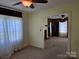 Living room with a doorway to another room and neutral carpeting at 412 Ridge St, Stanley, NC 28164