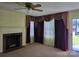 Living room with fireplace and decorative window coverings at 412 Ridge St, Stanley, NC 28164
