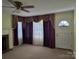 Cozy living room featuring a fireplace and large windows with decorative curtains at 412 Ridge St, Stanley, NC 28164