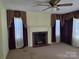 Living room featuring a fireplace and decorative curtains at 412 Ridge St, Stanley, NC 28164