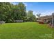 Large backyard features a tool shed, a dog house, and ample green space, perfect for recreation at 435 Stirewalt Rd, China Grove, NC 28023