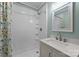 Bright bathroom featuring a white tiled shower and a modern vanity with a white countertop and brushed metal fixtures at 435 Stirewalt Rd, China Grove, NC 28023