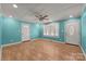 Bright and open bedroom with multiple doors, ceiling fan, and warm wood flooring at 435 Stirewalt Rd, China Grove, NC 28023