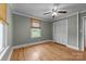 Bedroom featuring hardwood floors, neutral walls, a ceiling fan, and a large window with views of the outdoors at 435 Stirewalt Rd, China Grove, NC 28023