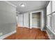 A bedroom featuring hardwood floors, ample closet space, and a large window providing natural light at 435 Stirewalt Rd, China Grove, NC 28023