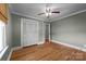 Bedroom with hardwood floors, neutral walls, a ceiling fan, and a closet with bi-fold doors at 435 Stirewalt Rd, China Grove, NC 28023