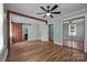 Bedroom with wood floors, light walls, sliding barn door, and a mirrored closet, offering a view into the en suite bathroom at 435 Stirewalt Rd, China Grove, NC 28023