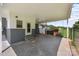 Spacious carport area featuring concrete flooring, a chain-link fence, and access steps at 435 Stirewalt Rd, China Grove, NC 28023
