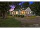 Exterior view of the residence, displaying its well-kept yard, inviting front porch, and mature trees at 435 Stirewalt Rd, China Grove, NC 28023