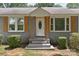 Close-up of the front door and facade with wood shutters and stone steps at 435 Stirewalt Rd, China Grove, NC 28023