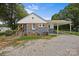 Charming home with gray brick and white siding, complemented by wood shutters and mature landscaping at 435 Stirewalt Rd, China Grove, NC 28023
