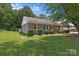 Charming home with brick accents and wood shutters, surrounded by manicured landscaping and a lush green lawn at 435 Stirewalt Rd, China Grove, NC 28023