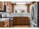 Bright kitchen featuring oak cabinets, white tile backsplash, and stainless appliances at 435 Stirewalt Rd, China Grove, NC 28023