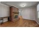 Cozy living room featuring a brick fireplace and wood paneled walls at 435 Stirewalt Rd, China Grove, NC 28023