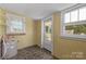 The sunroom features yellow brick walls, tile floors, and three windows for ample natural light at 435 Stirewalt Rd, China Grove, NC 28023