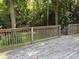Spacious wooden deck with sturdy railings offers an outdoor living space surrounded by trees at 438 Faith Sw Dr, Concord, NC 28027
