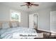 Primary bedroom with neutral walls, natural lighting, and a modern ceiling fan at 4429 Dawnwood Dr, Gastonia, NC 28056