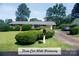 Charming one-story brick home with a well-maintained front lawn and an inviting three-car-wide driveway at 4429 Dawnwood Dr, Gastonia, NC 28056