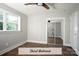 Well-lit third bedroom with a mirrored closet and wood flooring at 4429 Dawnwood Dr, Gastonia, NC 28056