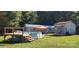Backyard featuring an above ground pool and wooden deck at 4688 Taxahaw Rd, Lancaster, SC 29720