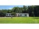 Single-story home with well and charming front porch amidst a lush, green lawn at 4688 Taxahaw Rd, Lancaster, SC 29720