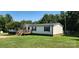 Charming home with a wooden deck, well-maintained lawn, and inviting curb appeal in a serene setting at 4688 Taxahaw Rd, Lancaster, SC 29720