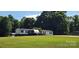 Charming home with green lawn and recreational vehicle, perfect for outdoor enthusiasts at 4688 Taxahaw Rd, Lancaster, SC 29720