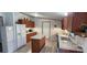 Spacious kitchen features an island, wooden cabinets, white appliances and modern flooring at 4688 Taxahaw Rd, Lancaster, SC 29720