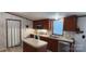 A well-lit kitchen with an island, wooden cabinets, stainless steel appliances and neutral countertops at 4688 Taxahaw Rd, Lancaster, SC 29720