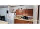 Bright kitchen with wooden cabinets, white appliances and neutral countertops at 4688 Taxahaw Rd, Lancaster, SC 29720