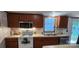 Traditional kitchen with wooden cabinets, stainless steel microwave, white appliances and neutral countertops at 4688 Taxahaw Rd, Lancaster, SC 29720