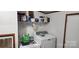 Functional laundry room with modern washer and dryer, and storage shelf at 4688 Taxahaw Rd, Lancaster, SC 29720