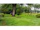 A sprawling backyard offers privacy and space, complete with mature trees and a storage shed at 5083 Fleetwood Dr, Hickory, NC 28602