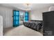 Bright bedroom featuring a comfortable bed, blue curtains, and natural light at 5083 Fleetwood Dr, Hickory, NC 28602